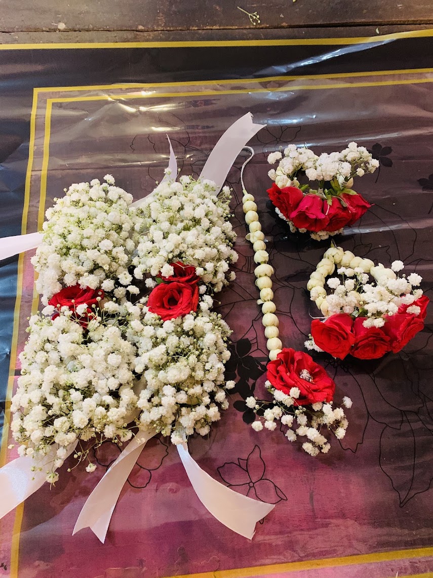 Red roses and white baby’s breath bridal flower jewellery set by Rukhsar Flowers